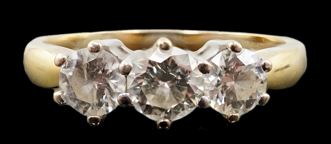 A modern 18ct gold and three stone diamond set ring